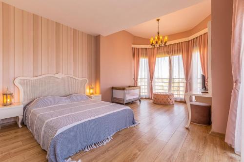 a bedroom with a large bed and two windows at VISTA Villa in Belek