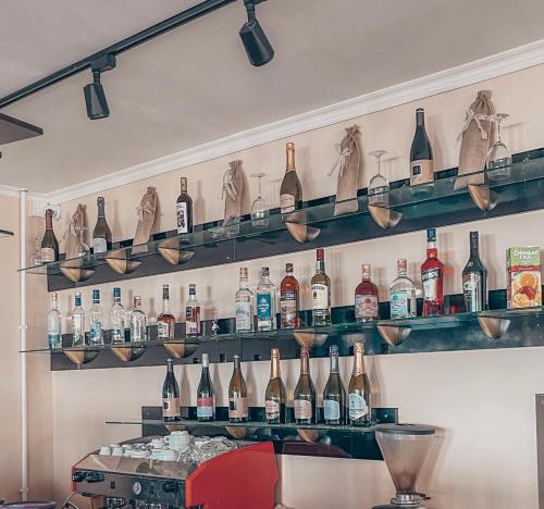 a bar with shelves of bottles on the wall at Yuzhnyy Bereg Hotel in Yeysk