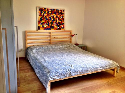 a bedroom with a bed and a painting on the wall at Casa Romea in Cividale del Friuli