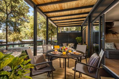 an outdoor patio with a table and chairs at Porton Mobile Home in Rovinj