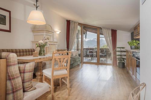 a kitchen and living room with a table and chairs at Aparthotel Stacherhof in Fügen