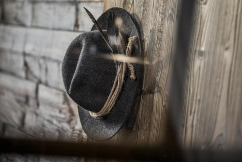 a hat hanging on a wall with a pair of scissors at Aparthotel Stacherhof in Fügen