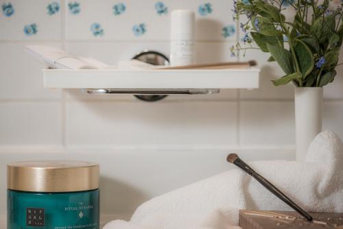 a bathroom counter with a roll of towels and a candle at Aparthotel Stacherhof in Fügen