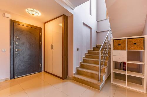 a hallway with a door and stairs in a house at VISTA Villa in Belek