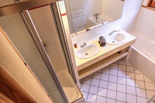 a small bathroom with a sink and a shower at Chardon Bleu in Peisey-Nancroix