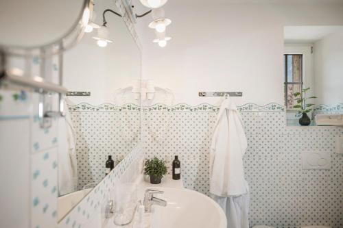 a bathroom with a sink and a mirror at Aparthotel Stacherhof in Fügen