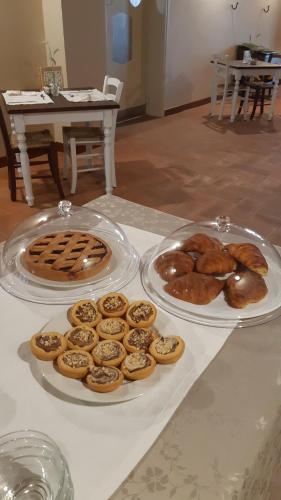 two plates of pastries and donuts on a table at La Locanda nel Frutteto in Rovereto