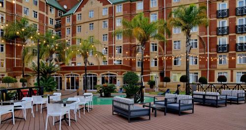 a large building with tables and chairs in front of it at ANEW Hotel Centurion Pretoria in Centurion