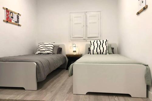 a bedroom with two beds and a couch at M5 Cool Terrace. Metro 1 min. Center 15' by metro in Esplugues de Llobregat