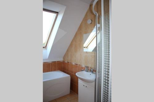 a bathroom with a sink toilet and a shower at Dom nad Morzem in Gąski