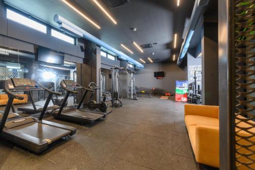 a gym with several tread machines in a room at Miamar Luxury Hotel & Spa in Himare