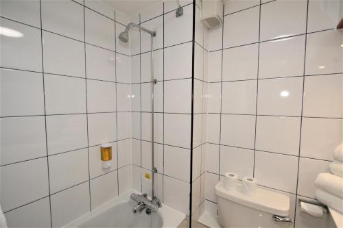 a bathroom with a sink, toilet and bathtub at The Oakwood Hotel by Roomsbooked in Gloucester