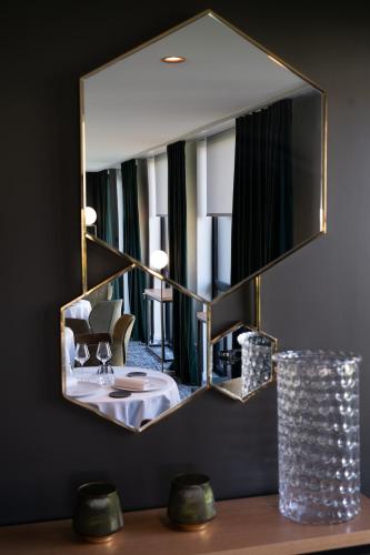 a bathroom with a sink and a mirror at Domaine la Charpinière, The Originals Collection in Saint-Galmier