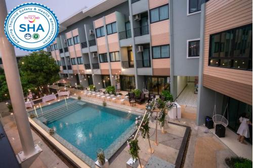 an overhead view of a hotel with a swimming pool at Phuket Airport Place - SHA Plus in Nai Yang Beach