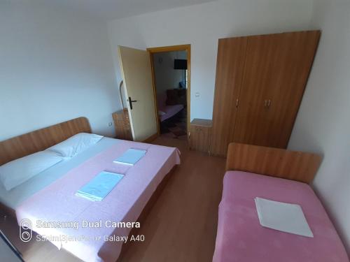 a bedroom with a bed and a chair in it at Apartmani Nevena in Herceg-Novi
