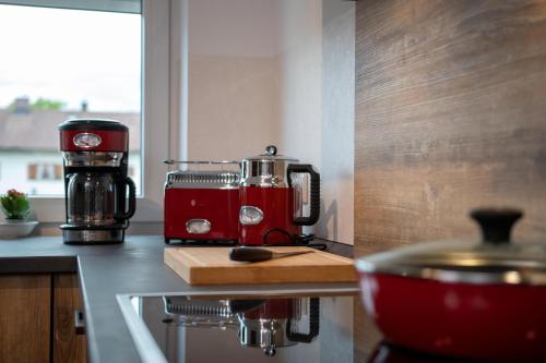 a red coffee maker sitting on top of a kitchen counter at Ferienwohnung FühlDichWohl in Übersee