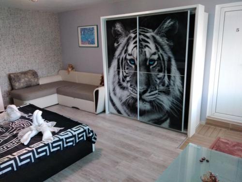 a room with a picture of a tiger on the wall at Къща за гости Синьо Лято in Pomorie