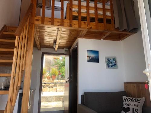 a stairway leading into a living room with wooden ceilings at Myrtos Harmony Apartments in Myrtos