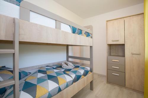 a small bedroom with bunk beds and a closet at Apartment Stella in Labin
