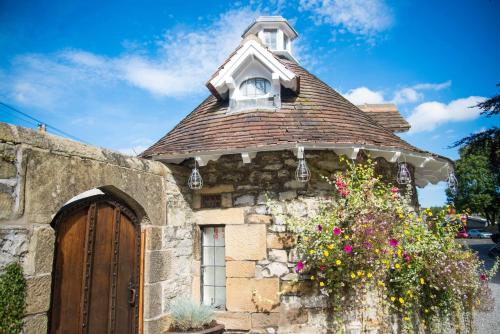 an old house with a window and a roof at Rafters at Riverside House Hotel in Bakewell