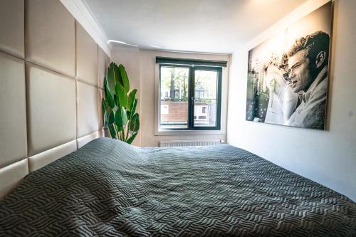a bedroom with a bed and a window at Amsterdam-Houseboat-Amstel in Amsterdam