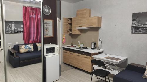 a small kitchen with a counter and a table at Квартира на Дерибасовcкой in Odesa