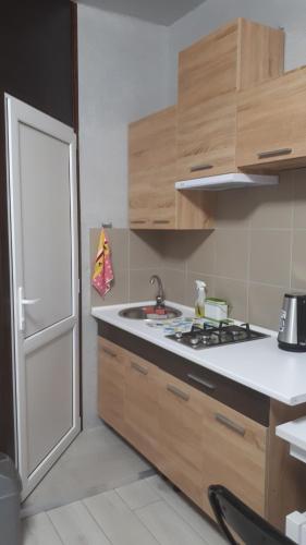 a kitchen with a sink and a stove and a door at Квартира на Дерибасовcкой in Odesa