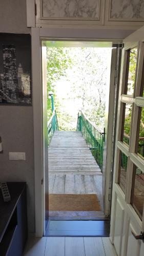 an open door to a porch with a wooden walkway at Квартира на Дерибасовcкой in Odesa