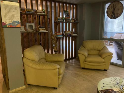 a living room with two chairs and a table at Olimpia Hotel in Fethiye