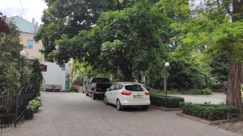 a white car parked on the side of a street at Квартира на Дерибасовcкой in Odesa