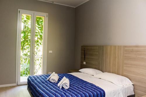 Postel nebo postele na pokoji v ubytování Hotel Sant'Orsola City House Collection by GSA Hotels