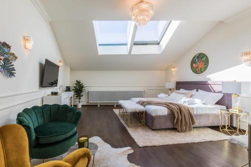 a bedroom with a bed and a skylight at HOLT Old Town Suites in Bucharest
