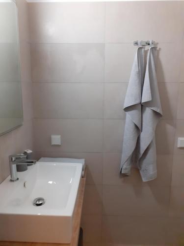 a white bathroom with a sink and a mirror at Pension Horvath jun. in Guntramsdorf