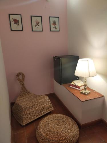 a room with a chair and a table with a lamp at Tenuta Mocajo in Guardistallo