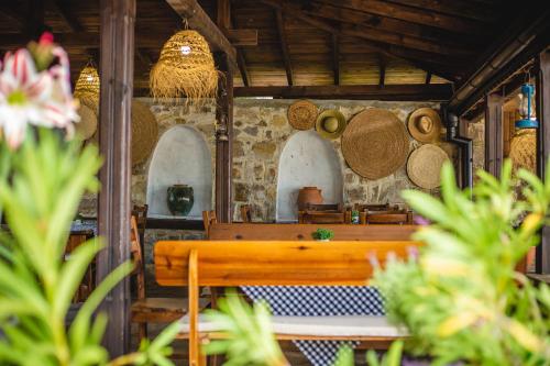 a room with a wooden bench and a wall with straw hats at VILLA SOL in Sunny Beach