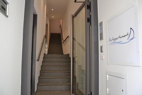 a staircase in a building with a glass door at RivAppartamenti in Riva del Garda