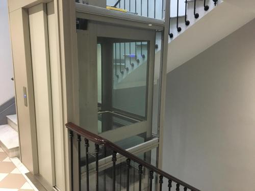 a stairway with a glass door on a staircase at Palais Gioffredo place Massena in Nice