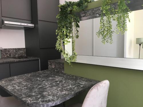 a kitchen with a marble table and a mirror at Palais Gioffredo place Massena in Nice