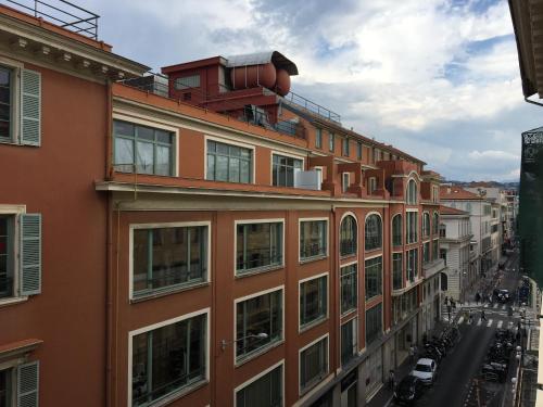 an apartment building with a street in front of it at Palais Gioffredo place Massena in Nice