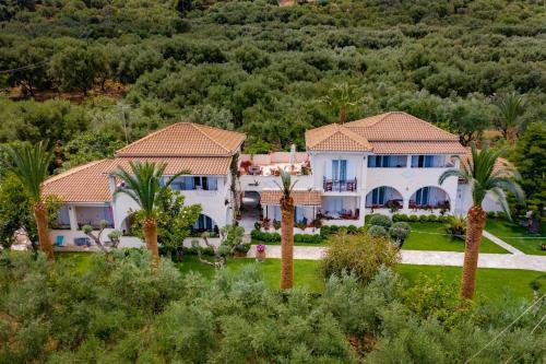 a house with palm trees in front of a mountain at Villa Phoenix in Keri