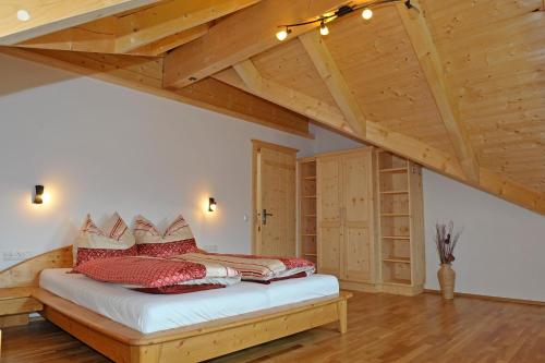 a bedroom with a bed in a room with wooden ceilings at Ferienhaus Johanna in Schladming