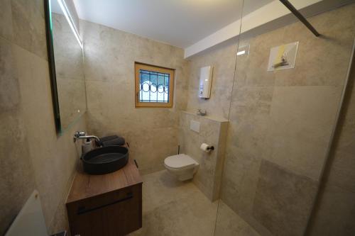 a bathroom with a sink and a toilet and a shower at Berghaus Turracherhöhe in Turracher Hohe