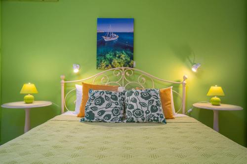 a bedroom with a bed with two side tables at Villa Phoenix in Keri