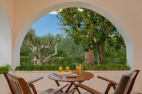 a table with glasses of orange juice on a patio at Villa Phoenix in Keri