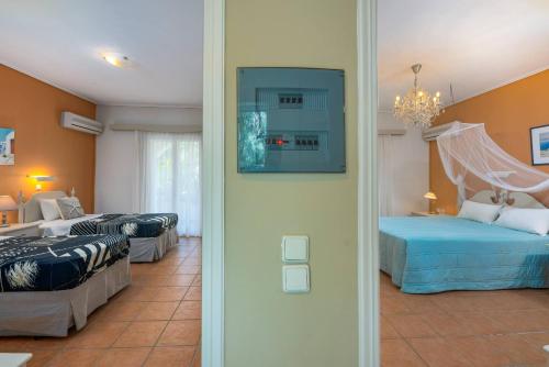 a hotel room with two beds and a room with two beds at Villa Phoenix in Keri