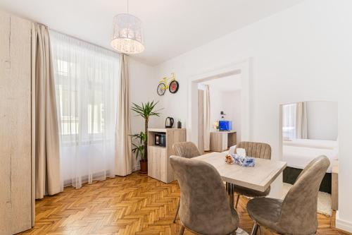 - un salon avec une table à manger et des chaises dans l'établissement Brasov Holiday Residence, à Braşov