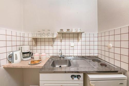 a kitchen with a sink and a counter top at Villa Phoenix in Keri