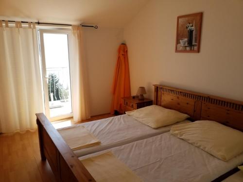 a bedroom with two beds and a window at Apartment Andrea in Novi Vinodolski