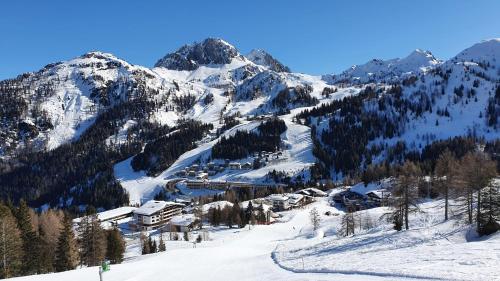 a snow covered mountain with a ski lodge on it at Apartment Sophia in Sonnenalpe Nassfeld