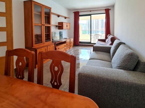 a living room with a couch and a table at Apartamento Completo Torresol I in Benidorm